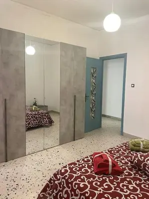 a bedroom with a large bed with a red bag on it at Casa Visconti 170mq-centro storico in Palermo
