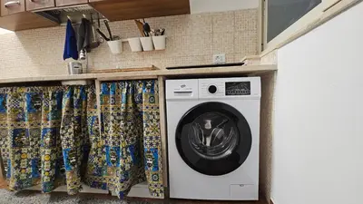 a washing machine in a kitchen with curtains at Dietro Ballarò - Guest House in Palermo