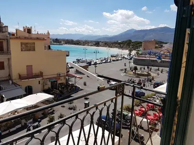 a view from a balcony of a town with a beach at Appartamento Mediterraneo Mondello in Palermo