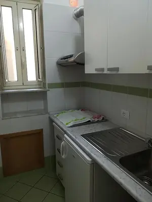 a kitchen with a sink and a counter top at Appartamento Mediterraneo Mondello in Palermo