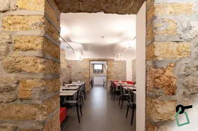 a restaurant with brick walls and tables and chairs at HOTIDAY Room Collection - Palermo Politeama in Palermo