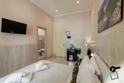a bedroom with a bed and a desk in a room at HOTIDAY Room Collection - Palermo Politeama in Palermo