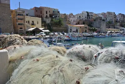 a bunch of nets in a harbor with boats at Villa Aliotis in Alcamo Marina