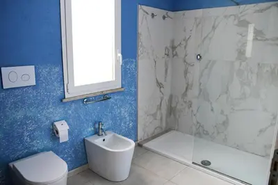 a bathroom with a shower and a toilet and a sink at Villa Luxury Fronte mare San Vito lo Capo in San Vito lo Capo