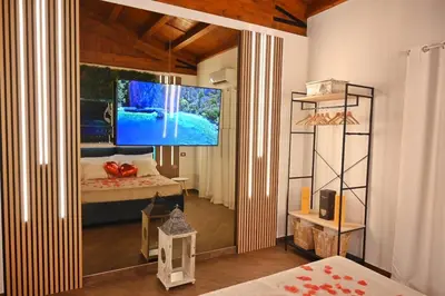 a bedroom with a large tv in the corner of a room at Cala Sikula Suite &SPA in Palermo
