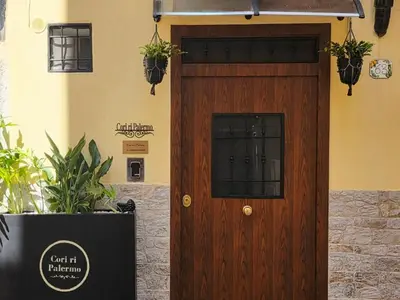 a wooden door with a window on a building at Cori ri Palermo in Palermo