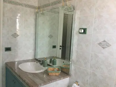 a bathroom with a sink and a mirror at Elegante Appartamento Palermo in Palermo