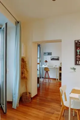 a kitchen with a white door and a refrigerator at Croce Barocca Apartment in Palermo