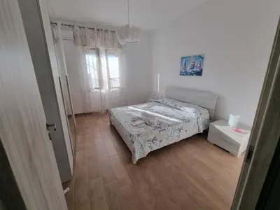 a small bedroom with a bed and a window at Pietra Marina in Capaci