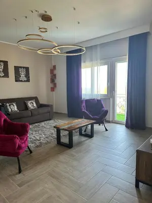 a living room with a couch and a table at Addaura Luxury Apartment in Palermo