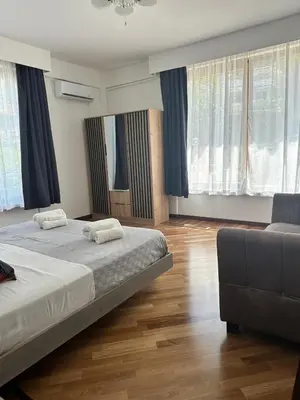 a bedroom with two beds and a couch at Addaura Luxury Apartment in Palermo