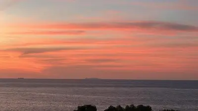 a sunset over the ocean with a pink at Addaura Luxury Apartment in Palermo