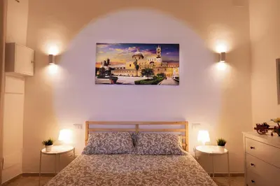 a bedroom with a bed and a painting on the wall at Palermo Home Politeama in Palermo