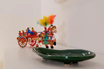 a toy horse pulling a cart with a green cucumber at Palermo Home Politeama in Palermo
