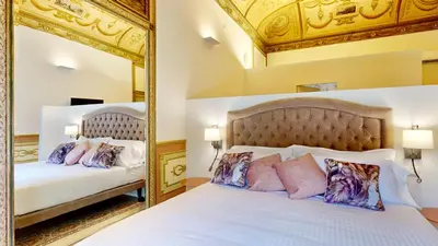 a bedroom with two beds and a mirror at Palazzo Genuardi - charming rooms - in Palermo