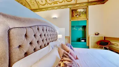 a bedroom with a large bed with a gold ceiling at Palazzo Genuardi - charming rooms - in Palermo