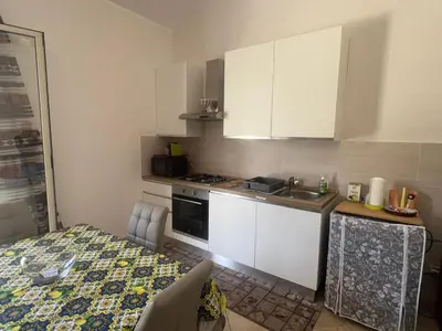 a small kitchen with a sink and a stove at Carini house in Carini