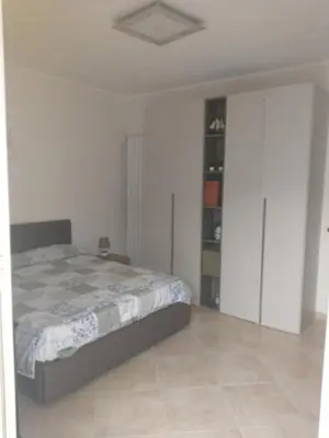 a bedroom with a bed and a book shelf at Carini house in Carini
