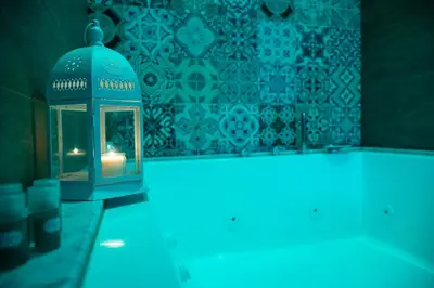 a lantern with a candle in a room with a wall at Palazzo Carella in Palermo