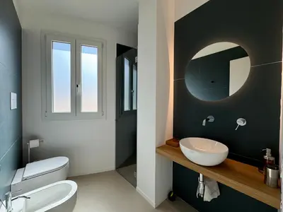 a bathroom with a sink and a mirror at Politeama Libertà Home Sweet Home in Palermo