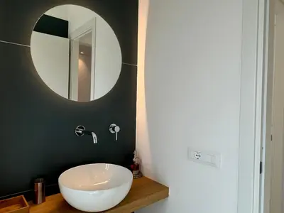 a bathroom with a white sink and a mirror at Politeama Libertà Home Sweet Home in Palermo