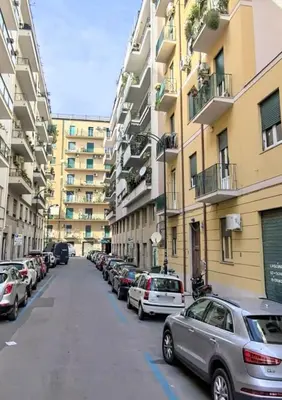a row of cars parked in a parking lot next to buildings at Quattru Passi in Palermo