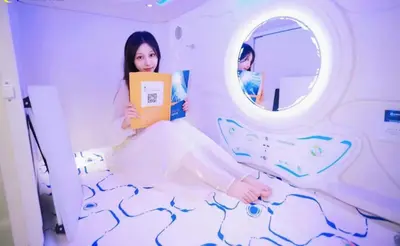 a woman in a hospital room holding a book at Mermaid Space Capsule Hostel Palermo in Palermo