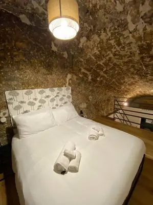 a bedroom with a white bed with towels on it at Appartamento Centro Storico in Palermo