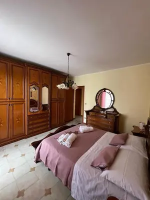 a bedroom with a large bed and a mirror at Casa MaRo' in Capaci