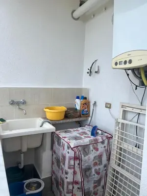 a small kitchen with a sink and a box at Casa MaRo' in Capaci
