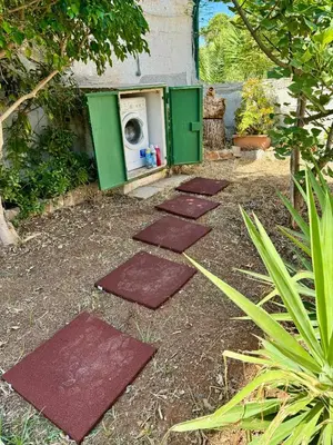 a row of stepping stones leading to a washing machine at Villa Mia in Carini