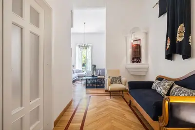 a living room with a blue couch and a chair at Libertà Appartement in Palermo