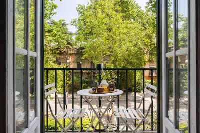 a balcony with a table and two chairs at Libertà Appartement in Palermo