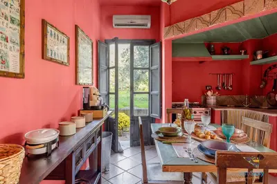 a kitchen with red walls and a table with food on it at Verosicily Panoramic House with access to the sea in Terrasini