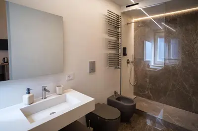 a bathroom with a sink and a shower and a toilet at Vissi d'Arte Rooms in Palermo