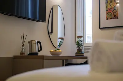 a room with a table with a mirror on the wall at Vissi d'Arte Rooms in Palermo