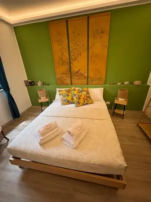 a bedroom with a large bed with towels on it at La Casa di Trudy in Palermo