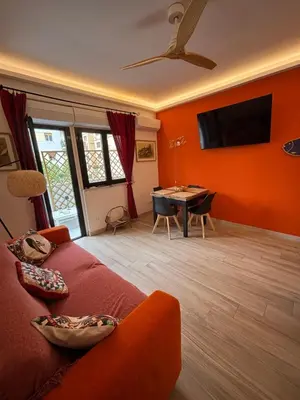a living room with a red couch and a table at La Casa di Trudy in Palermo