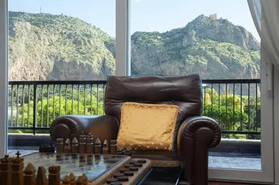 a leather chair sitting in front of a window at Casa Adele in Palermo