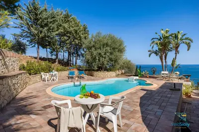 a villa with a pool and a table and chairs at Verosicily Villa Glicine in Termini Imerese