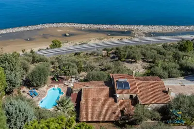 an aerial view of a house with a swimming pool and a beach at Verosicily Villa Glicine in Termini Imerese