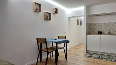 a kitchen with a table and two chairs in a room at Casa Salina Suite in Palermo