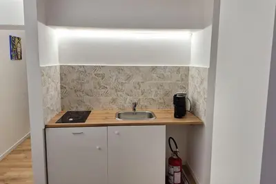 a kitchen with a sink and a counter top at Casa Salina Suite in Palermo