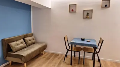 a room with a couch and a table and a table and chairs at Casa Salina Suite in Palermo