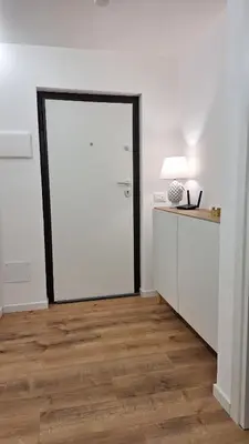 a room with a white door and a desk with a lamp at Casa Salina Suite in Palermo