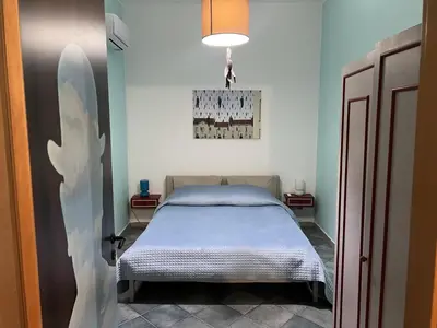 a small bedroom with a bed in a room at Le Stanze di Magritte in Palermo