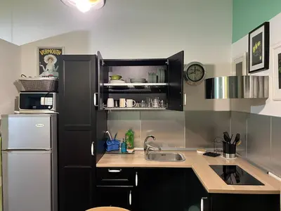 a small kitchen with a sink and a refrigerator at Le Stanze di Magritte in Palermo