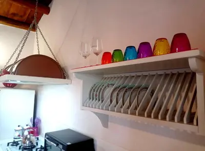 a shelf filled with wine glasses and wine glasses at Casa Mary in Castellammare del Golfo