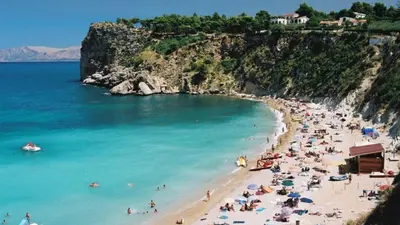 a group of people on a beach in the water at Casa Mary in Castellammare del Golfo