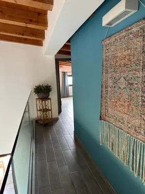a hallway with a brick wall with a painting on it at Stella Del Mare in Scopello